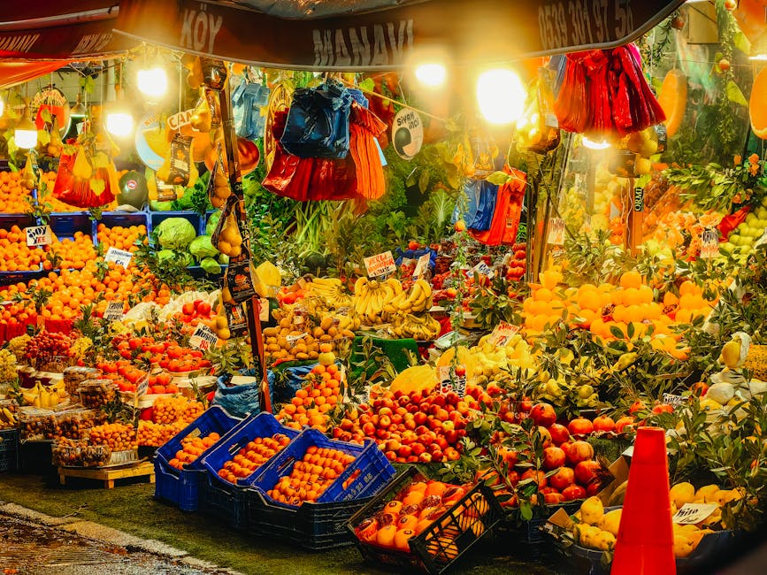 Colorful fruits and vegetables beautifully displayed at a bustling night market stall in Istanbul.