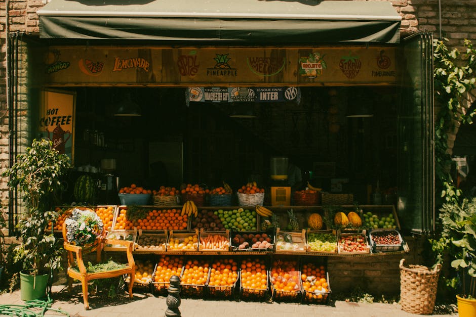 Colorful market stall with fresh fruits and vegetables displayed outdoors.